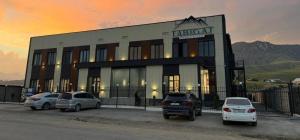 a building with cars parked in front of it at Tabigat Hotel & Spa in Alga