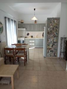 a kitchen with a table and a refrigerator at SG House in Bolátion