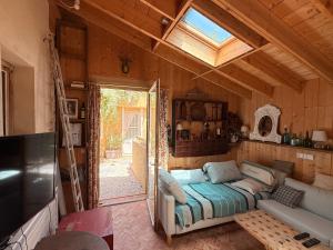 a living room with a couch and a skylight at beachhousebarn in Vendays-Montalivet