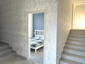 ein Schlafzimmer mit einem Bett neben einer Treppe in der Unterkunft White Location in Dzoraghpʼyur + 13 Fotos