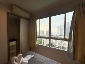 a bedroom with a large window with a view of a city at lumpini naklua wongamat in North Pattaya +39 photos