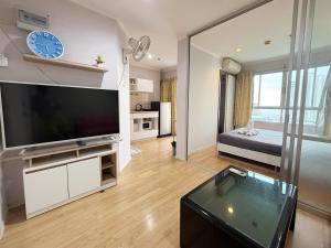 a living room with a large flat screen tv at lumpini naklua wongamat in North Pattaya