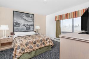 Voodi või voodid majutusasutuse Super 8 by Wyndham Stettler toas