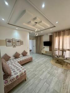 a large living room with a couch and a television at Penthouse Sousse in Sousse