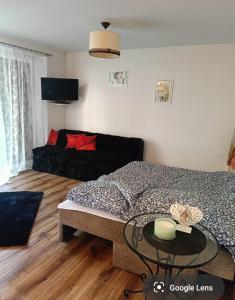 a bedroom with a bed and a glass table at Oliwa in Gdańsk