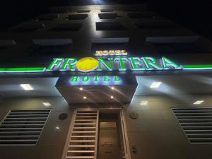 a hotel sign on the side of a building at Hotel Frontera in Antofagasta