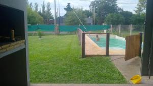 a boy in a swimming pool in a backyard at Quincho Paysandu in Arroyo Seco +4 photos