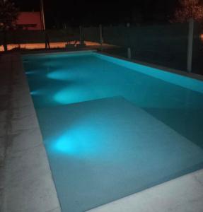 a swimming pool lit up at night at Quincho Paysandu in Arroyo Seco