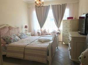 a bedroom with a bed and a dresser and a television at Oryx Homes & Villas in Bodrum City