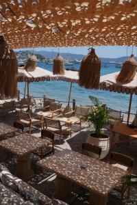 a group of tables and chairs under an umbrella at YU Townhouse in Bodrum City
