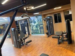 a gym with a row of treadmills and weights at Veena Vihar Homestay in Jodhpur