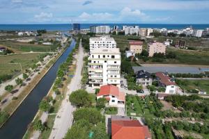 an aerial view of a building next to a river at Sunrise Apartment Qerret in Kavajë