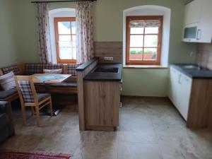 a kitchen and dining room with a table and a counter at Biohof Fötschl in Tamsweg