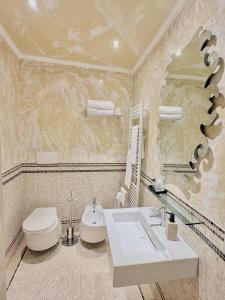 a bathroom with a sink and a toilet and a mirror at Antica Residenza Dell'Angelo in Lucca +24 photos