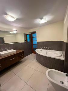 a bathroom with a tub and a sink and a bath tub at Oaza Spokoju in Gdynia +14 photos