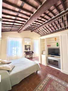 a bedroom with a large bed and a fireplace at Antica Residenza Dell'Angelo in Lucca
