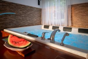 ein Badezimmer mit einem Waschbecken, in dem eine Wassermelone liegt in der Unterkunft Vila Stanjevac, Sarajevo in Sarajevo