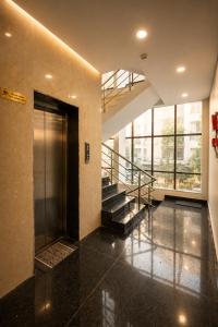 a lobby with a elevator and stairs in a building at Hotel Banyan Courtyard Guwahati in Guwahati