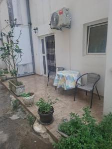 a patio with a table and chairs and plants at Harmony in Budva