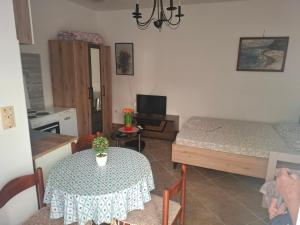 a room with a table and a bed and a kitchen at Harmony in Budva