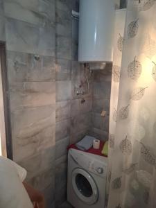 a bathroom with a washing machine and a shower at Harmony in Budva
