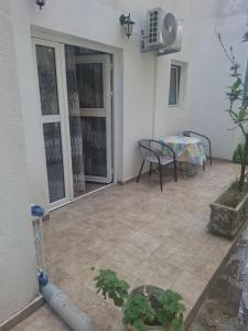 a patio with a table and chairs in a house at Harmony in Budva