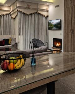 a living room with a bowl of fruit on a table at White Bloom - Kfardebian 6836 in Kfardebian