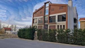 a building with a fence in front of it at White Bloom - Kfardebian 6836 in Kfardebian