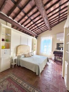 a bedroom with a large bed and a piano at Antica Residenza Dell'Angelo in Lucca