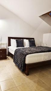a bedroom with a large bed in a room at White Bloom - Kfardebian 6836 in Kfardebian