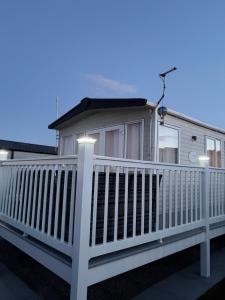a white mobile home with a white fence at Drake 17 in Scarborough