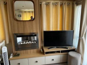 a living room with a television and a fireplace at Drake 17 in Scarborough