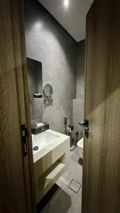 a bathroom with a sink and a toilet at فندق شفت جازان Shift Jizan Hotel in Jazan +13 photos