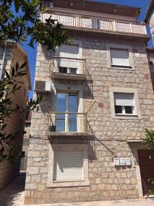 a stone building with balconies on the side of it at Katarina in Kaštela +7 photos
