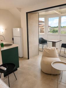 a living room with a couch and a table and chairs at Apartments Provence in Sozopol