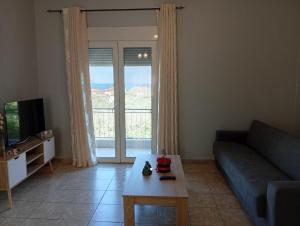 a living room with a couch and a coffee table at Thassos Home in Skala Kallirachis