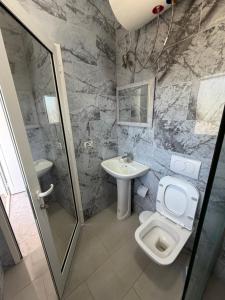 a bathroom with a toilet and a sink at Lalëz Villa Hoxha in Fushë-Draç +21 photos