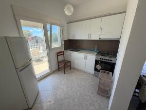 a kitchen with a refrigerator and a stove top oven at Lalëz Villa Hoxha in Fushë-Draç