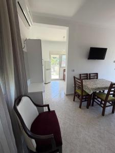 a kitchen and dining room with a table and chairs at Lalëz Villa Hoxha in Fushë-Draç