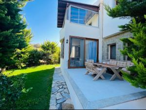 a house with a picnic table in front of it at Oryx Homes & Villas in Bodrum City