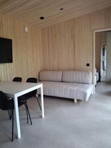 a white couch in a room with a table at Cottage in Raahe in Raahe