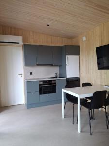 a kitchen with a table and chairs and a refrigerator at Cottage in Raahe in Raahe