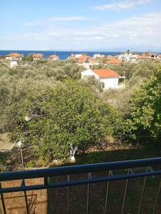 a view from a balcony of a town with a tree at Thassos Home in Skala Kallirachis