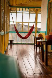 a hammock in a room with tables and windows at Hotel Ciudad de Segorbe in Salento