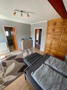 a bedroom with a large bed and wooden cabinets at Fefe Apartman in Balatonlelle