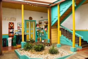 a house with a blue and yellow stair case at Hotel Ciudad de Segorbe in Salento