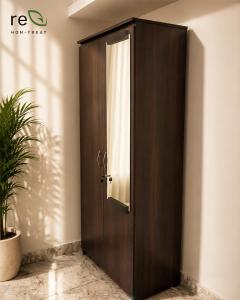 a wooden door in a room with a plant at Re-Leaf Hom-Treat Homestay in Wayanad +7 photos