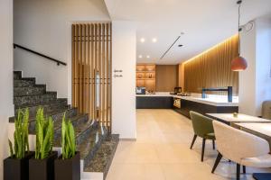 a kitchen and dining room with a staircase in a house at Anesea City in Heraklion