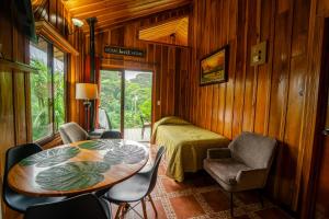 a room with a table and chairs and a bed at Cabañas Hoja Verde in Monteverde Costa Rica +47 photos
