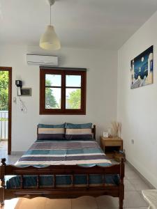 a bedroom with a bed in a room at SDROSOS Apartment in Kos